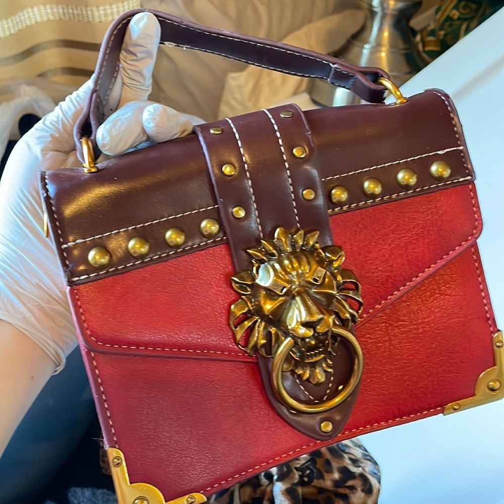 Red lion face clutch purse